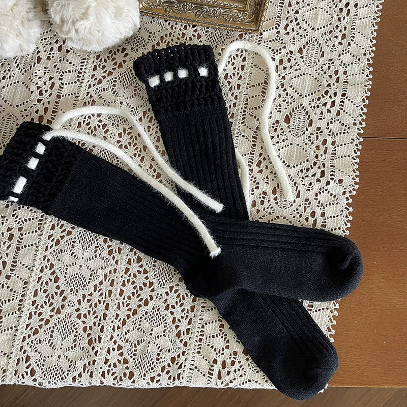 White ribbed legwear with crochet cuffs and long bow ties.