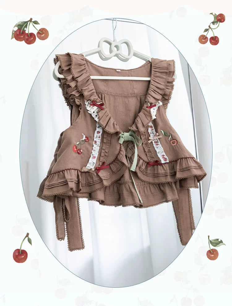 Red cherry-print OP dress with gingham panels and a ruffled brown coat.