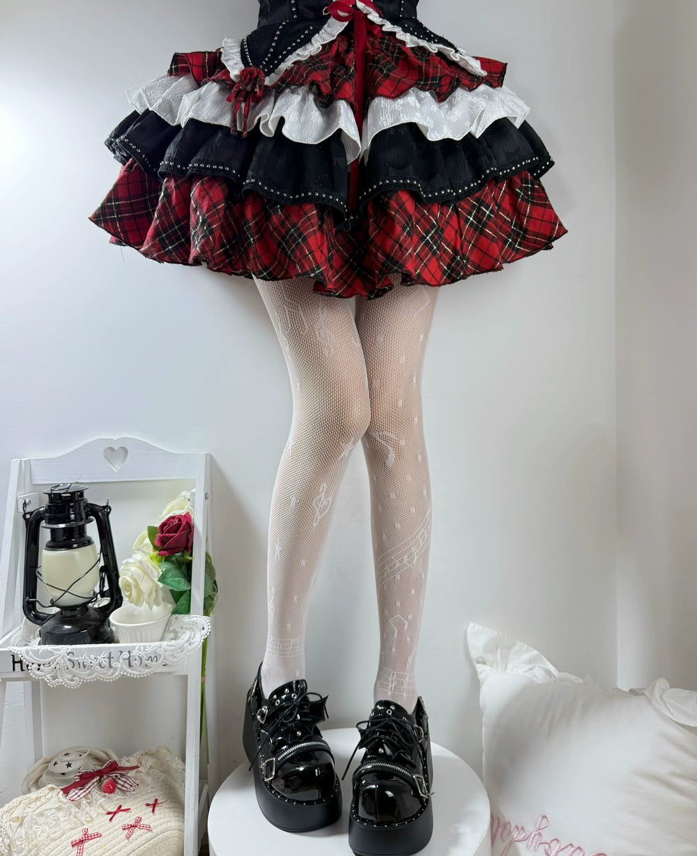 Black patterned fishnet tights with music-note motifs styled beneath a ruffled skirt.