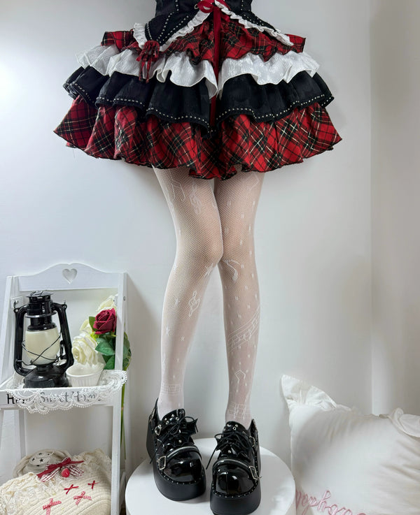 Black patterned fishnet tights with music-note motifs styled beneath a ruffled skirt.