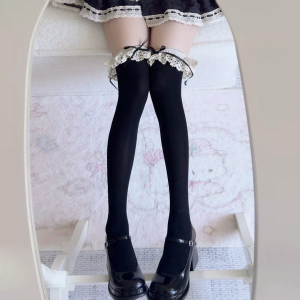 Black velvet over-the-knee socks with lace cuffs and ribbon ties