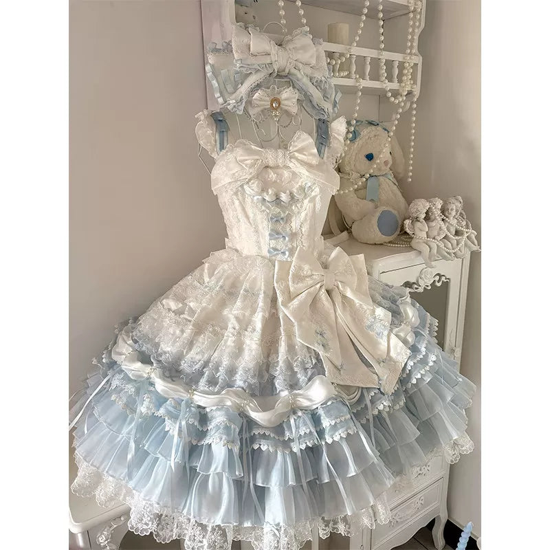 Blue-and-white layered lace JSK dress displayed on a dress form with a large waist bow.