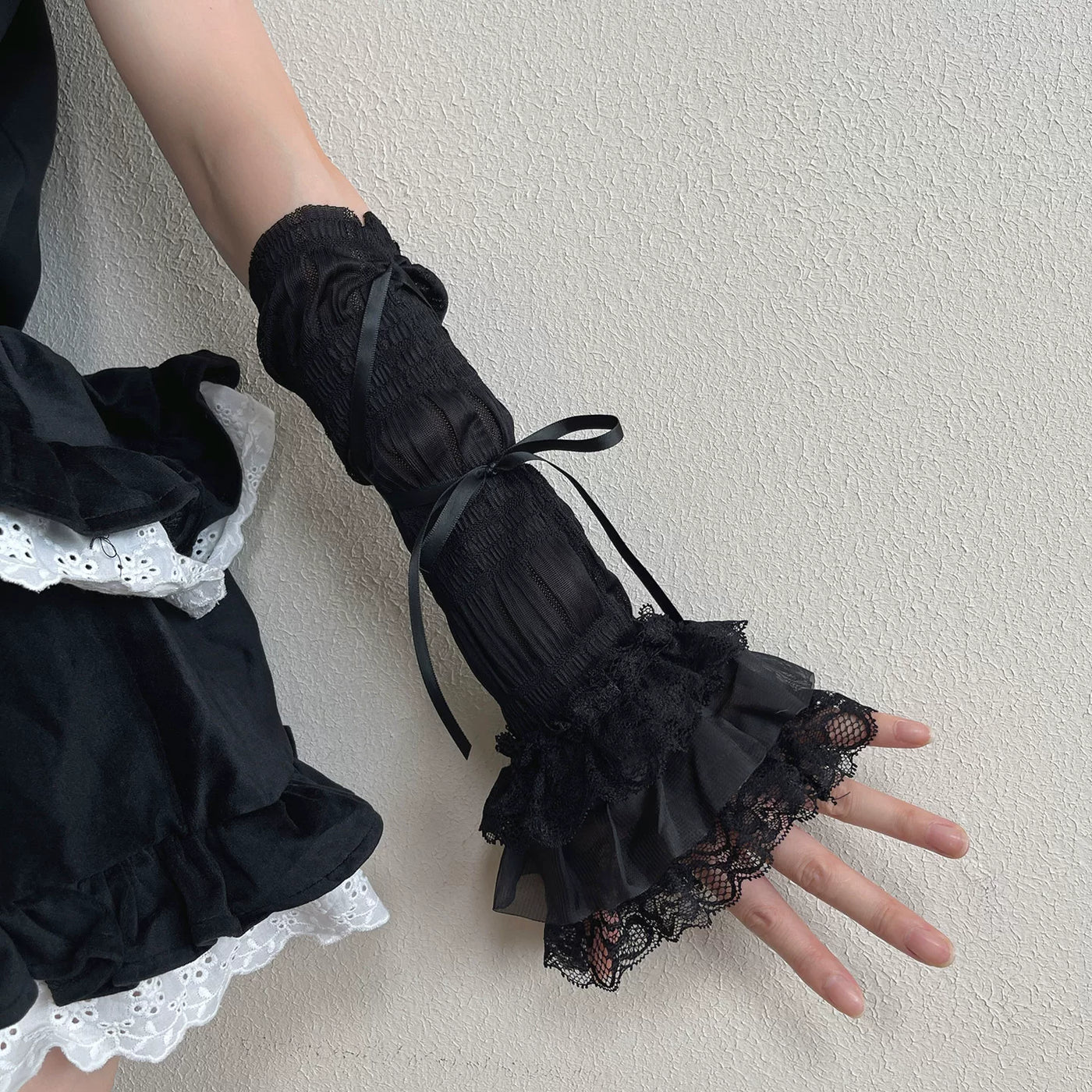 Long black lace fingerless gloves with ruffle cuffs and ribbon ties