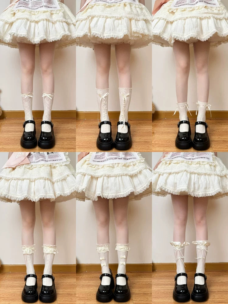 Model wearing pale cream lace socks with a ruffled cuff and bow detail.