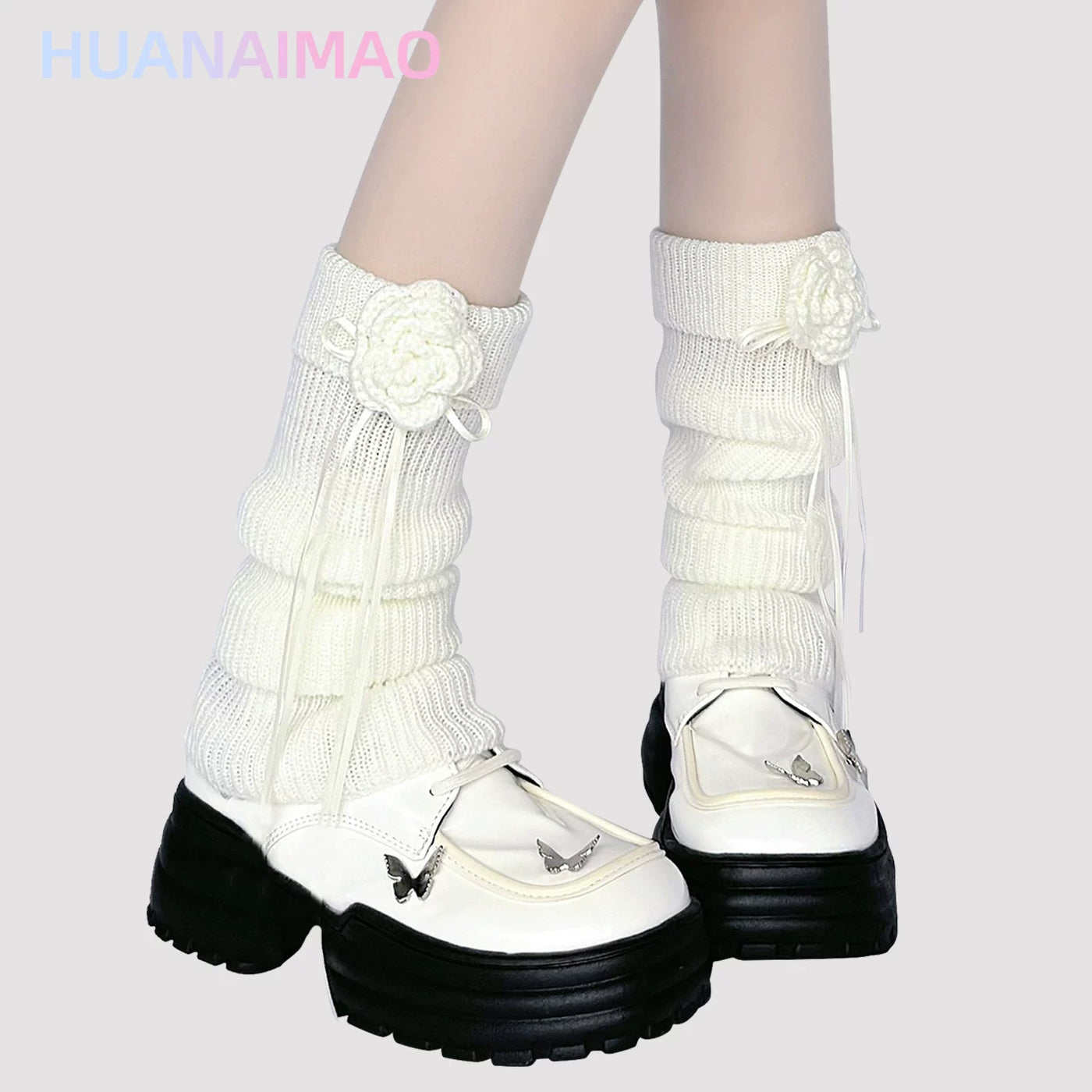 Light brown ribbed knit leg warmer with crochet floral appliqué and ribbon tie