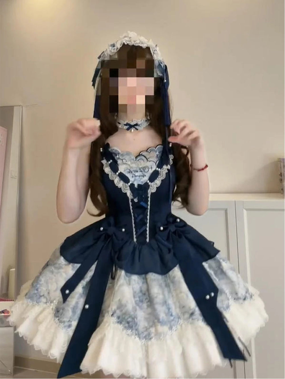 Blue-and-white Lolita dress with contrast panels, bows, and a full layered skirt.