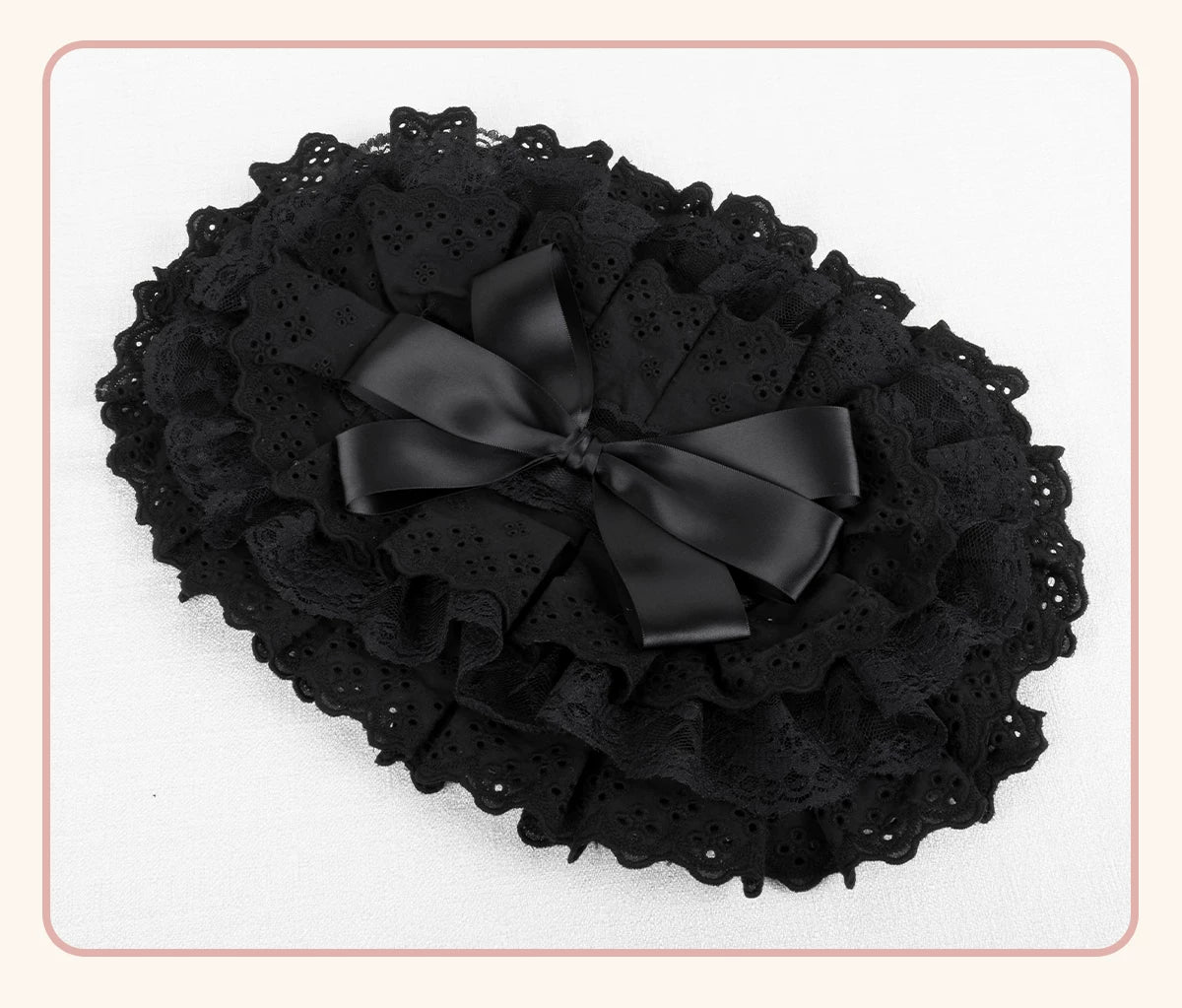 Black BNT flat hat with layered lace trim and ribbon bow displayed on a white background.