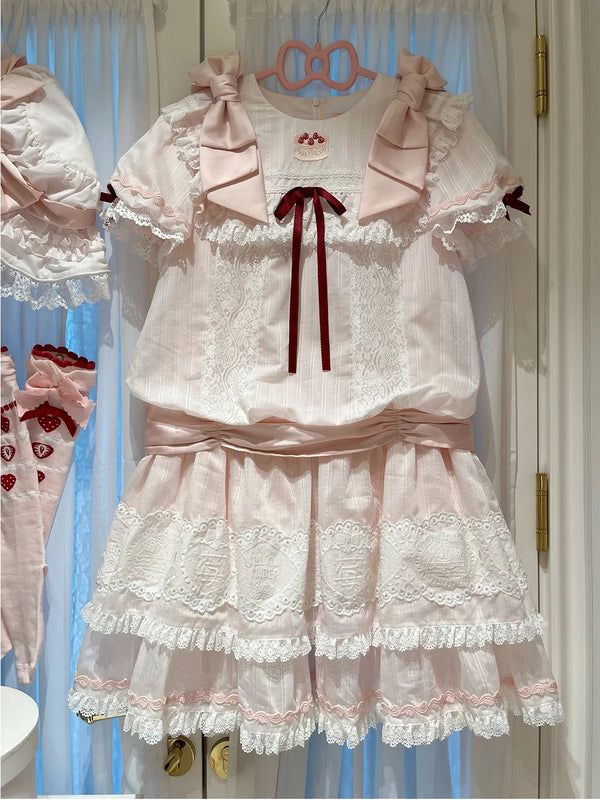 Pink-and-white low-waist OP dress with lace trim and pink bows.