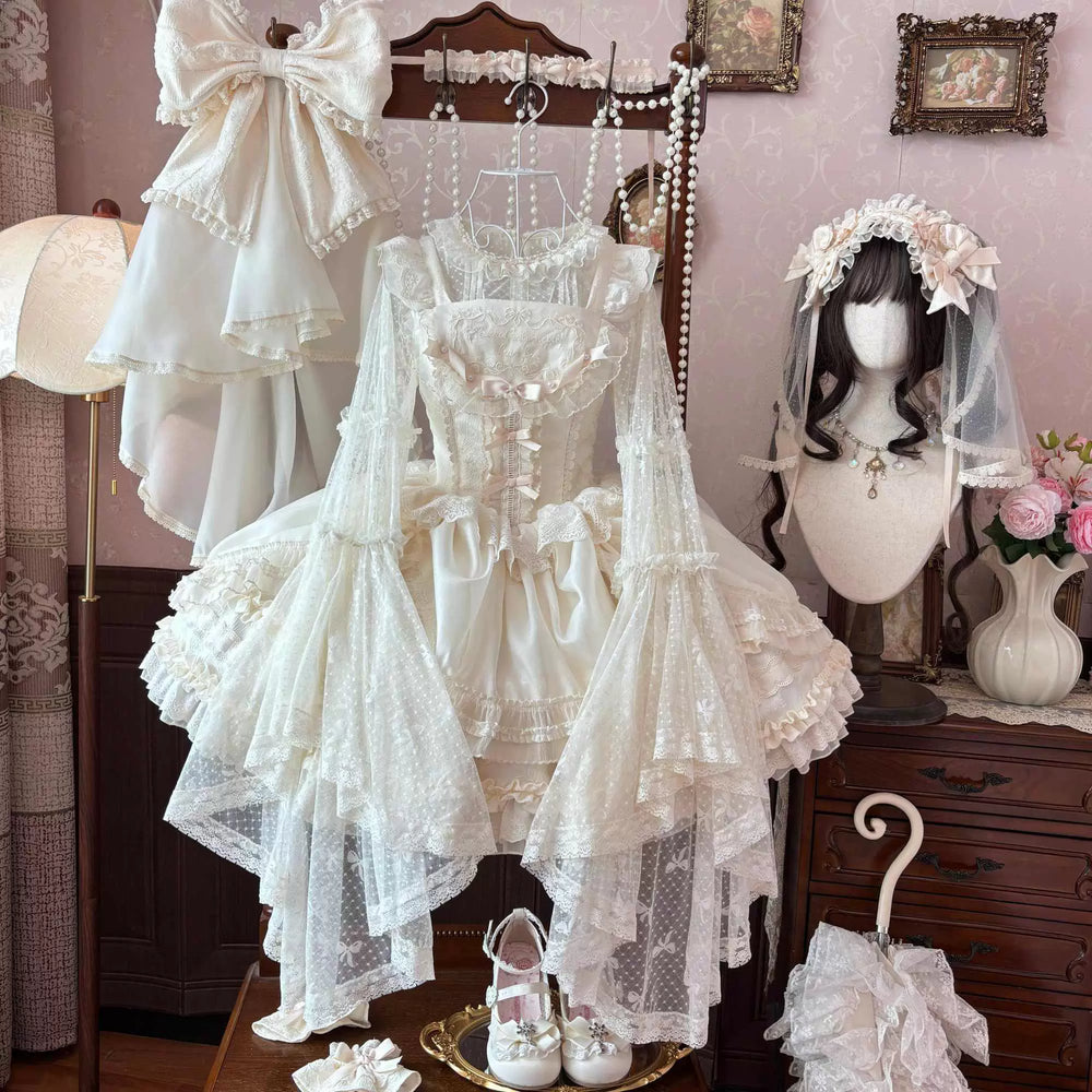 Sweetheart Dream Machine lace blouse and layered accessories displayed in a pink-and-white room.