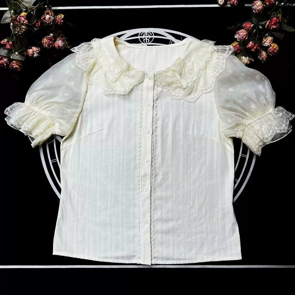 White lace-collar blouse with puff sleeves laid flat.