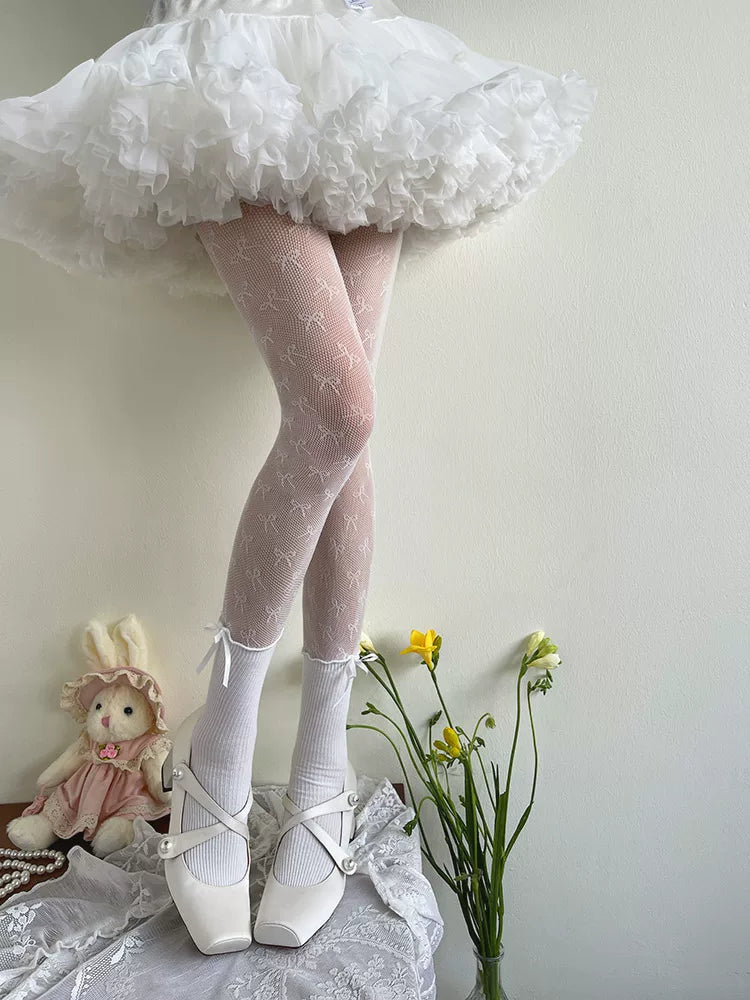 White sheer tights with repeated bow motifs worn beneath a ruffled skirt.
