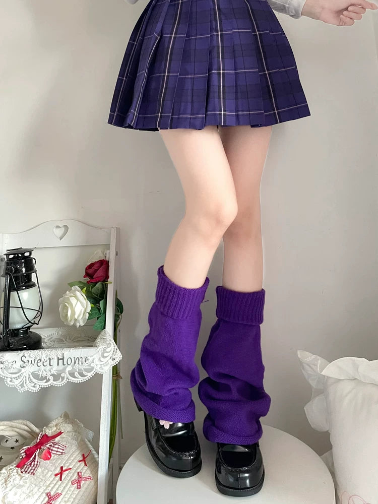 Purple scrunched knitted leg warmers worn over black platform shoes.