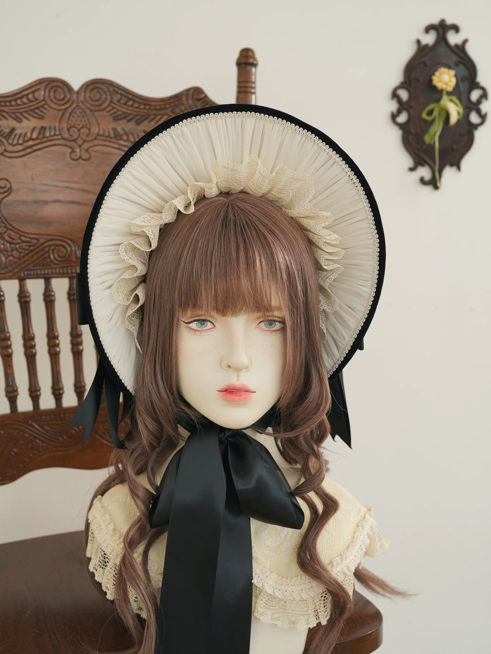 Star Box ChevalDoll lace-trimmed velvet bonnet with a large bow shown on a mannequin head.