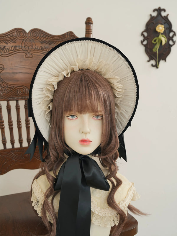 Star Box ChevalDoll lace-trimmed velvet bonnet with a large bow shown on a mannequin head.