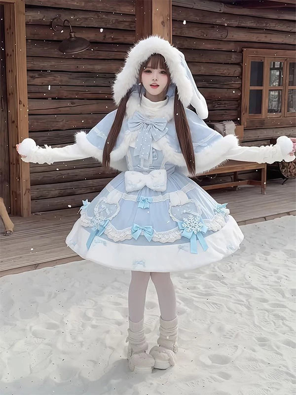 Modelled views of a pale-blue Lolita outfit with a fluffy-trimmed cape in a snowy outdoor setting.