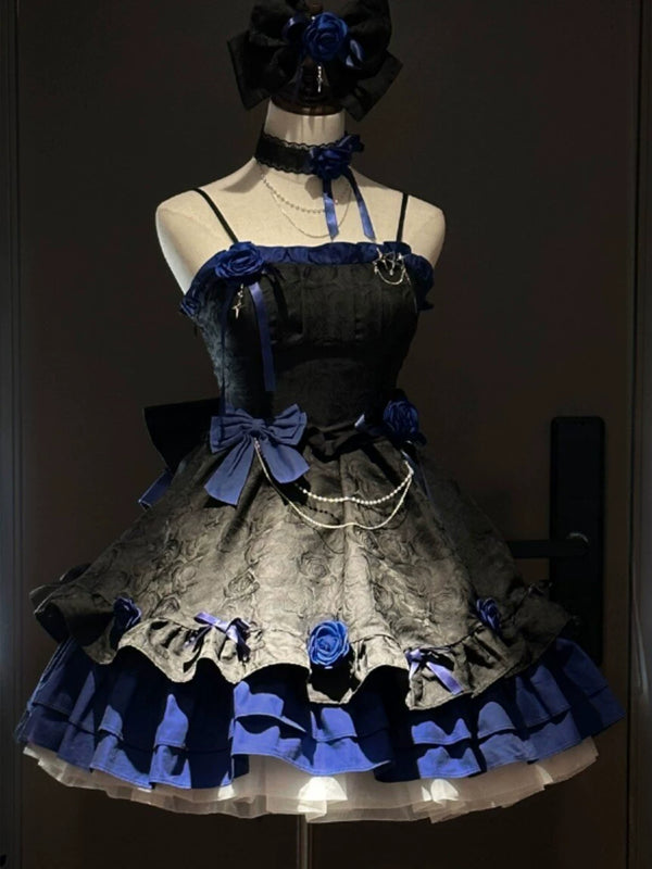 Black and blue Gothic JSK dress with blue roses and tiered ruffles on a mannequin.