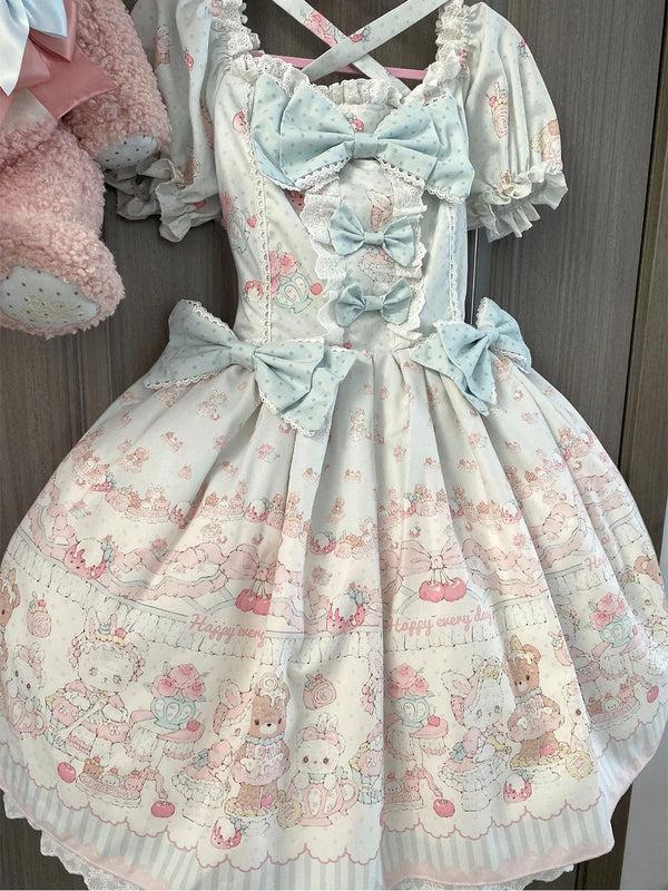 Creamy Blue Bear OP dress with bear print, blue bows, lace trim and puff sleeves displayed on a hanger.