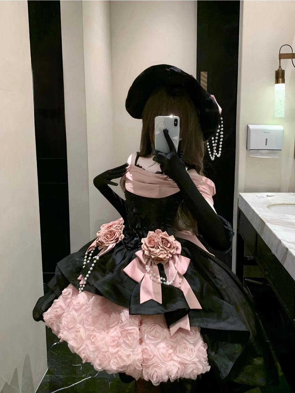 Black-and-pink rose JSK set with hat, bows, and pearl strands shown in a mirror styling photograph.