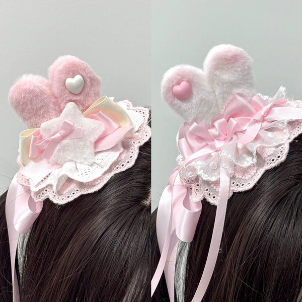 Pink and white bunny-ear lace hair accessory with long ribbon tails.