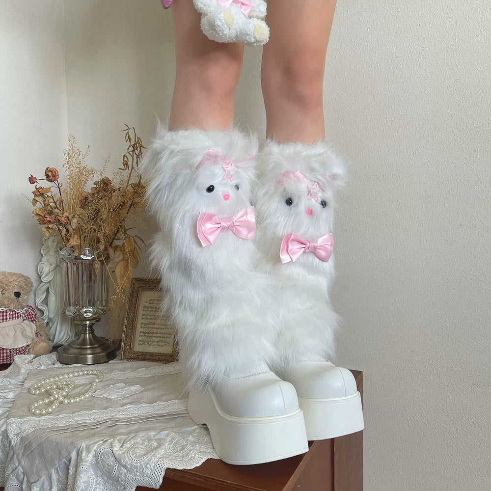 White fluffy sock covers with pink bows and a strawberry bear clip ring styled with white platform shoes.
