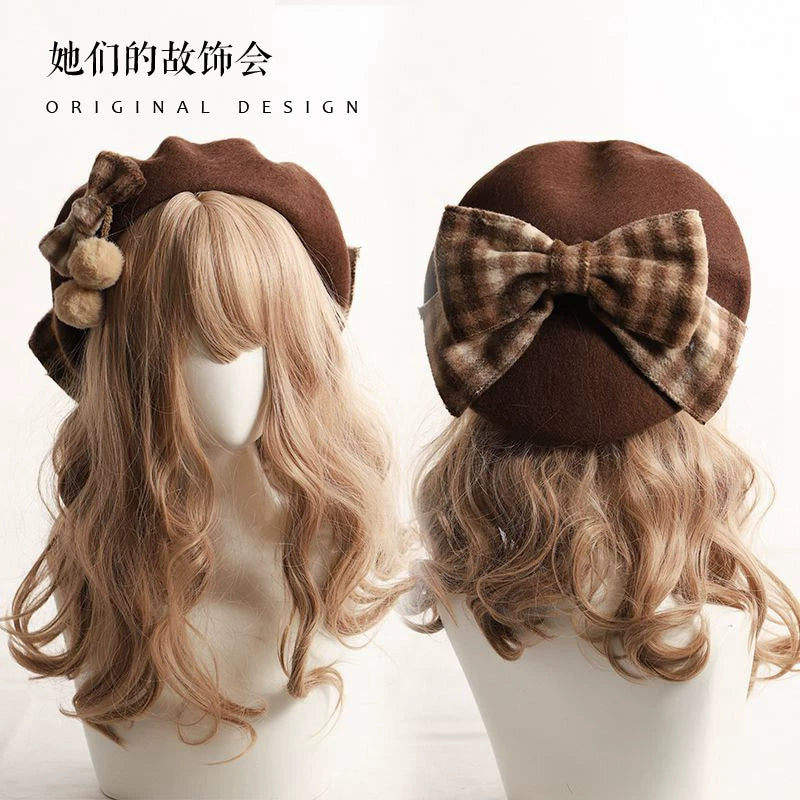Brown beret with a large plaid bow shown from front and back on a wig mannequin.