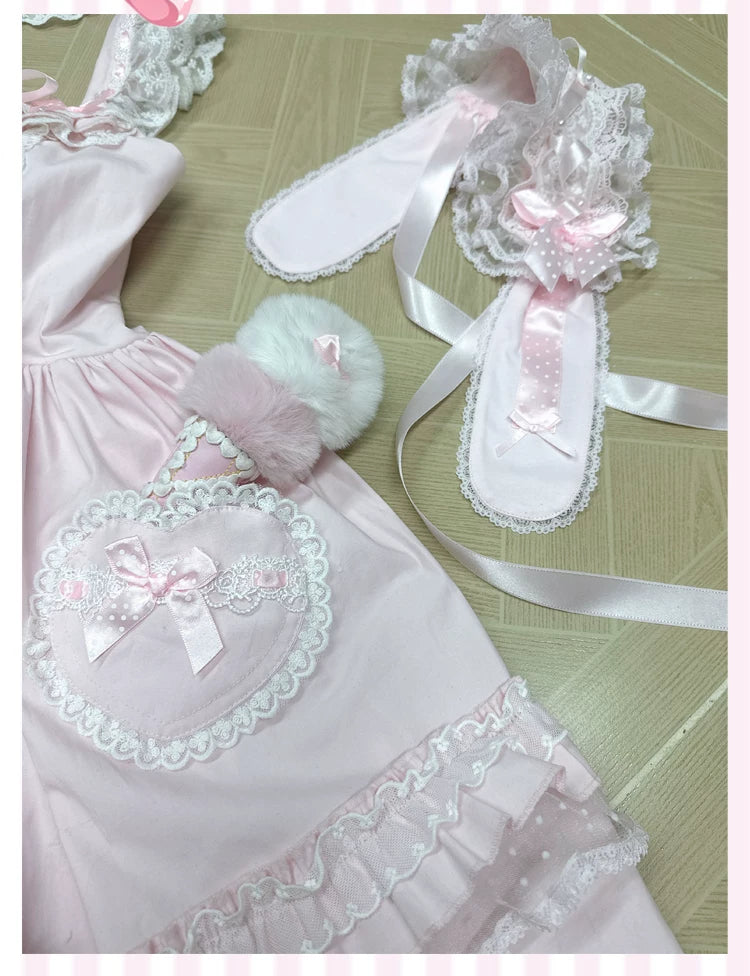 Pink-and-white tiered-ruffle JSK dress with a large bow shown front and back on mannequins.