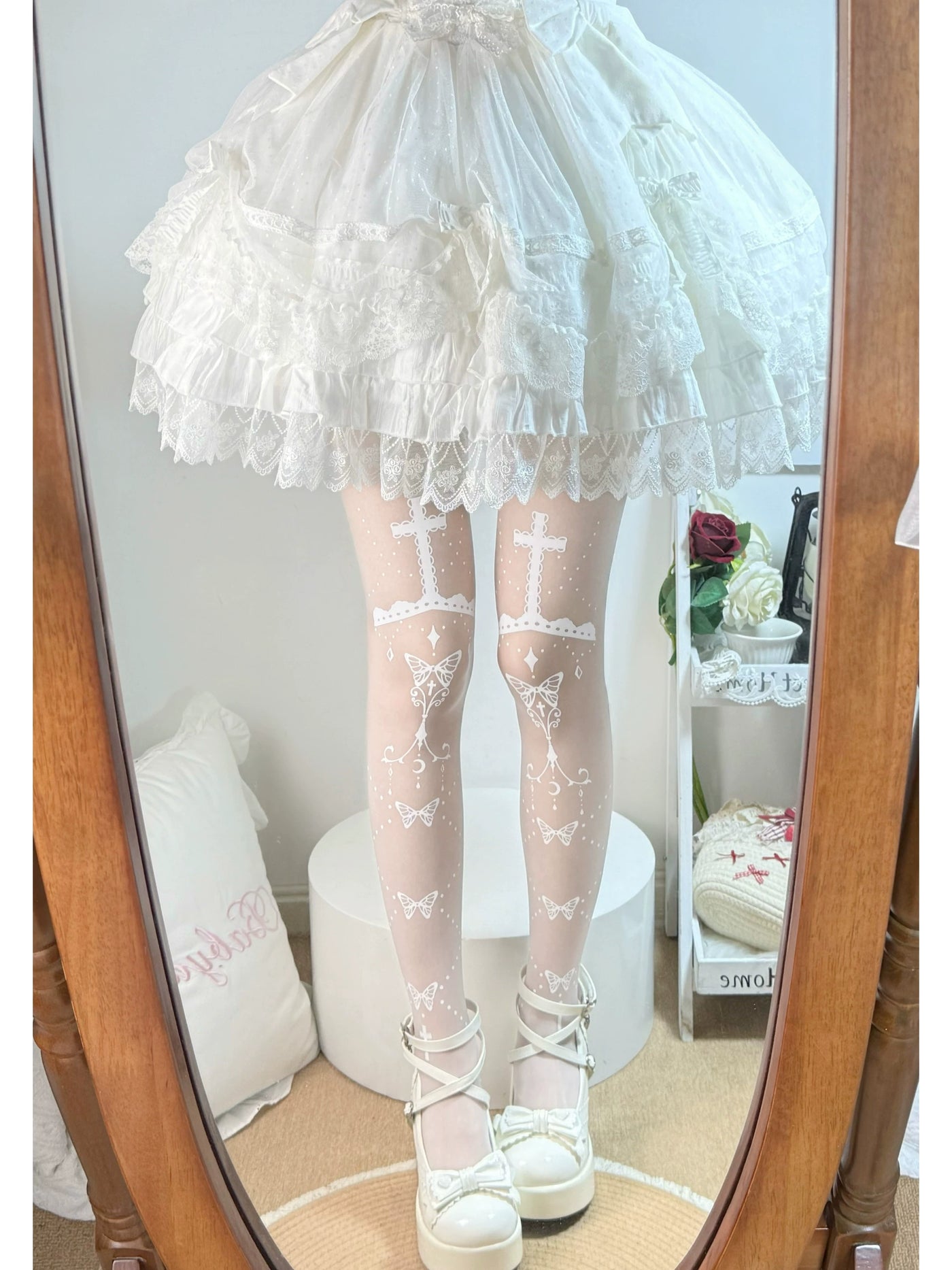 Fantasy Doll printed pantyhose with butterfly and prayer-cross motifs in a mirror styling photo
