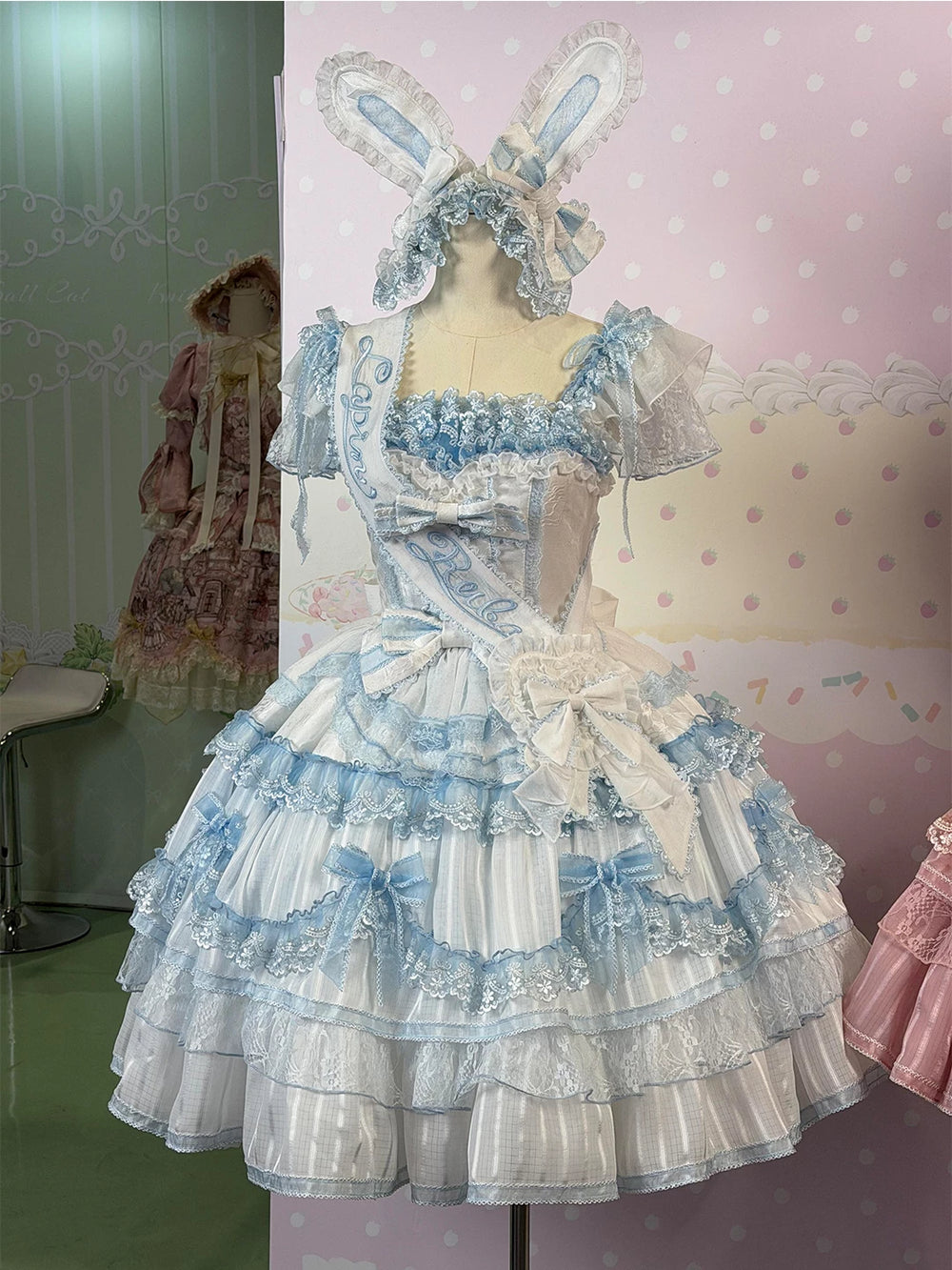 Blue-and-white rabbit-ear JSK set with sash on a mannequin