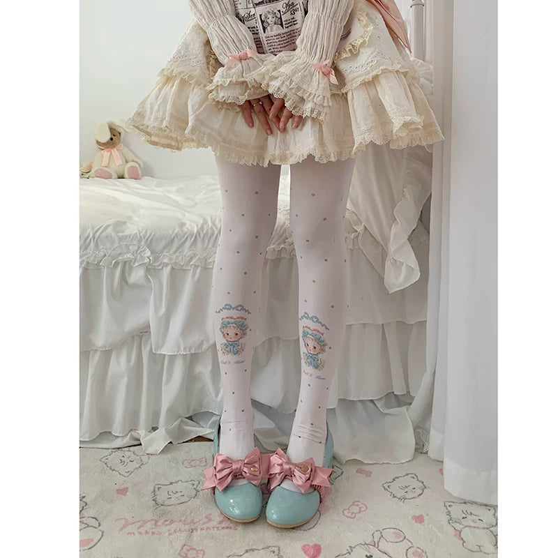 Printed tights with doll portraits and scattered dots styled beneath a layered skirt
