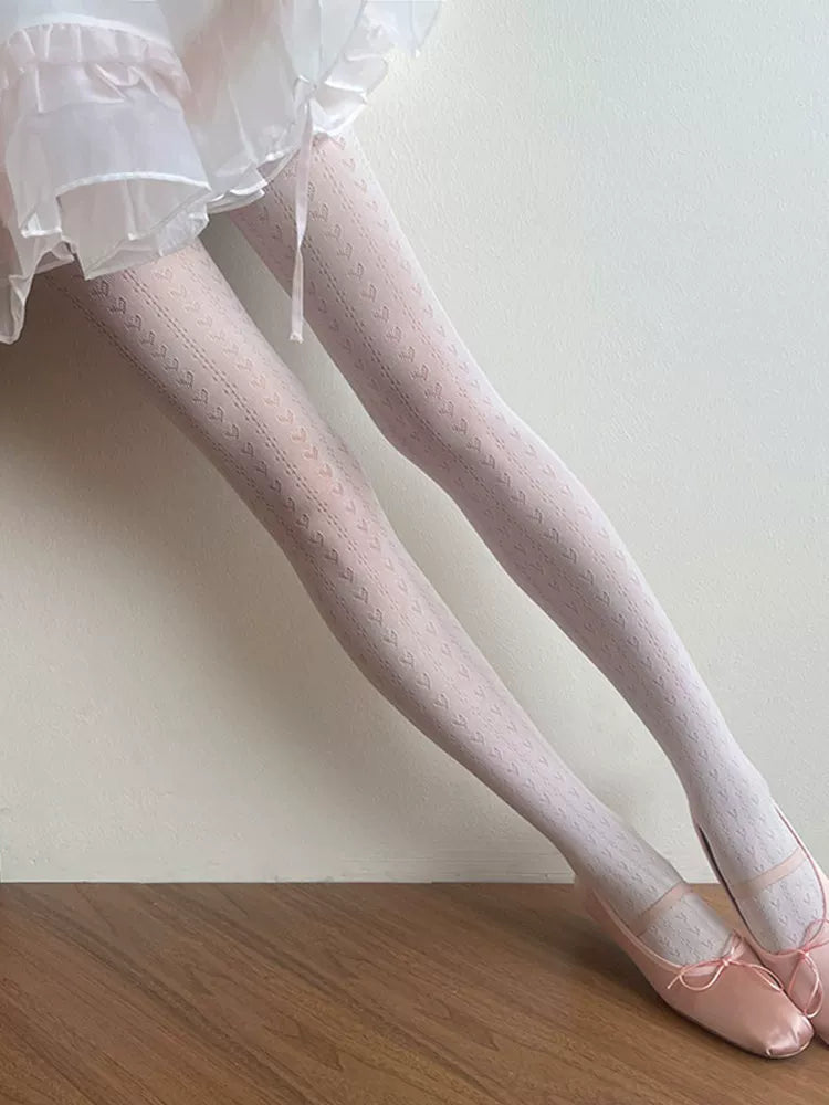 White heart-pattern lace tights styled with a ruffled white skirt and pink shoes.