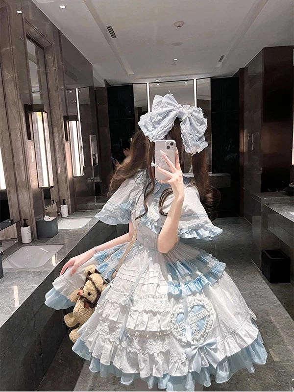 Blue-and-white Lolita JSK set with a heart-accented cape, bows and layered ruffles.