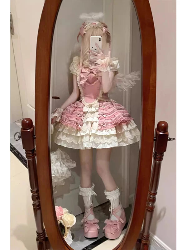 Front view of pink sweet Lolita three-piece coord with tiered ruffle half skirt, lace-trimmed blouse, and bow-front bustier