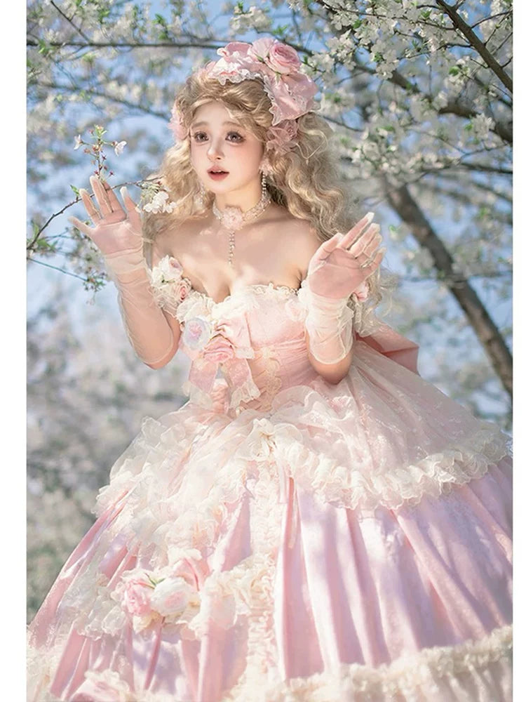 Mannequin displaying strapless blush pink lolita ballgown dress with corset back lacing and tiered ruffled skirt