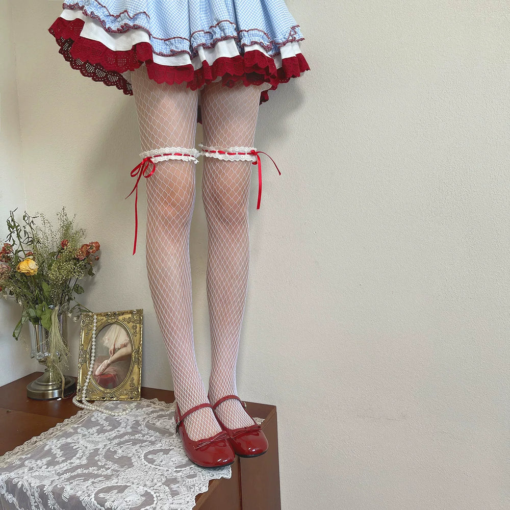 White fishnet pantyhose with red lace ribbon bands styled with a blue gingham skirt and red Mary Jane shoes.