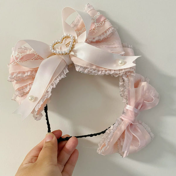 candycoco light-pink lace headband with layered bows, pearl accents, and ruffled trim