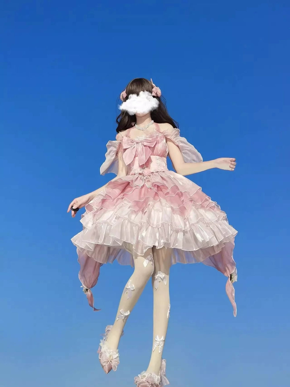 Creamy pink layered ruffle jumper skirt shown from the front and back on a model.