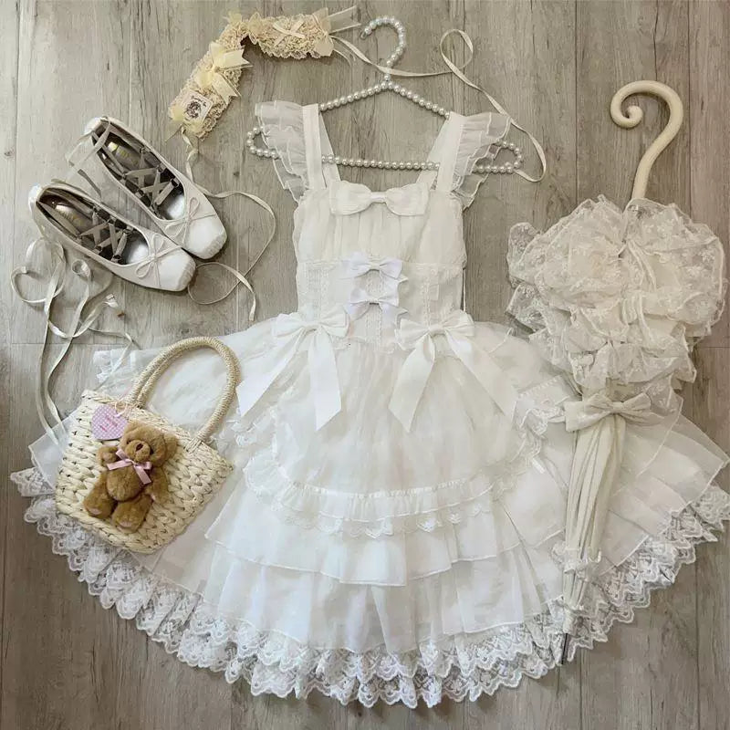 White or black JSK dress with layered ruffles and bow details shown in mirror photographs.