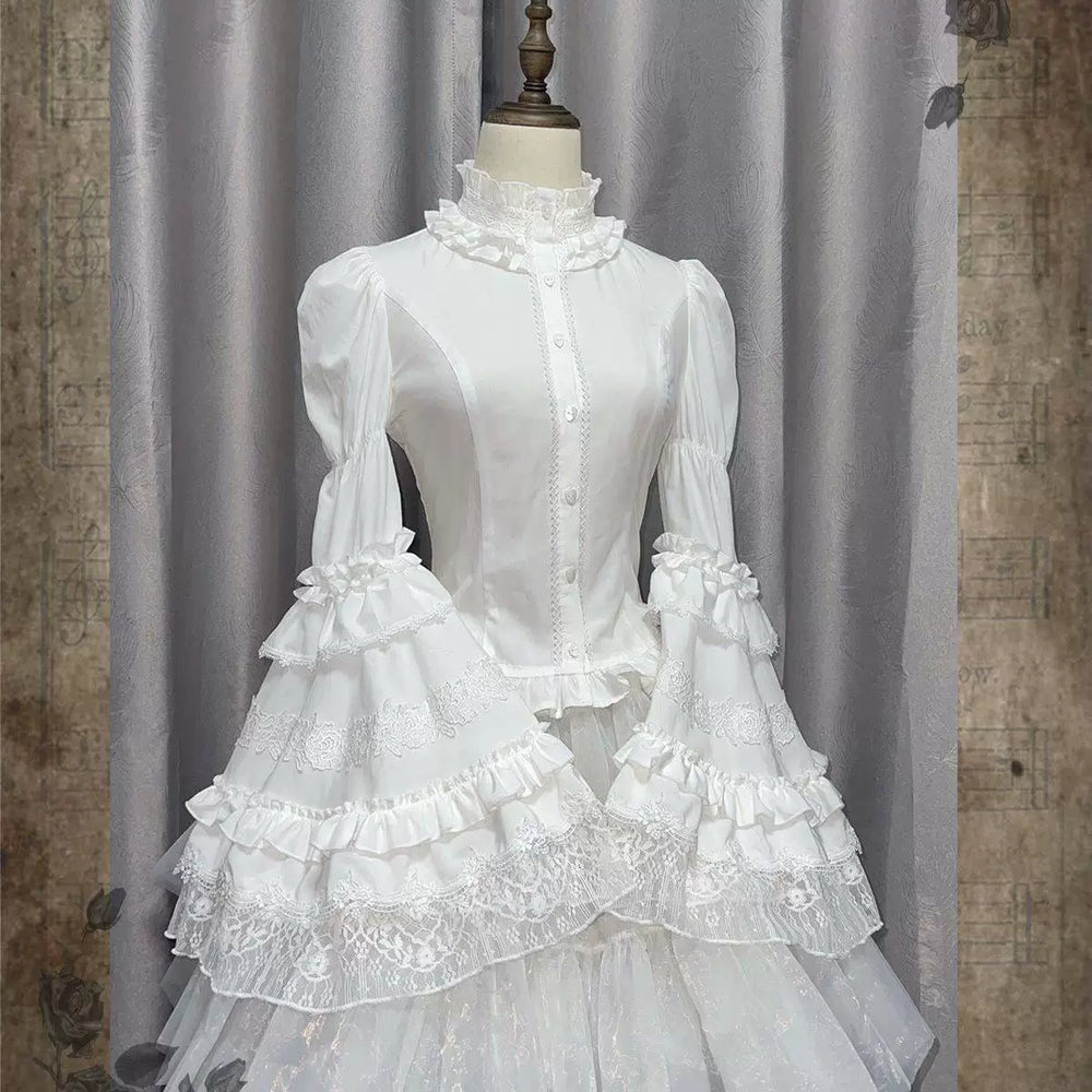 White long-sleeve blouse with high ruffled collar, puffed sleeves and lace cuffs