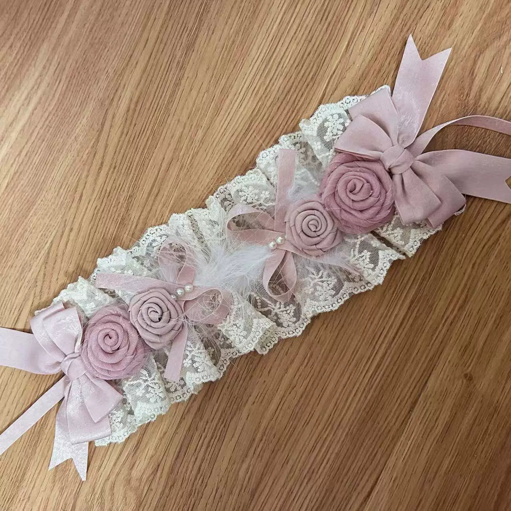 Satin-pink lace accessory with ribbon bows and hand-rolled roses