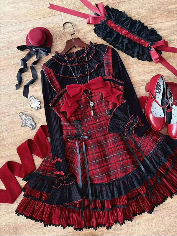 Red tartan three-piece JSK set with black inner layer and coordinating cape arranged on a wood floor.
