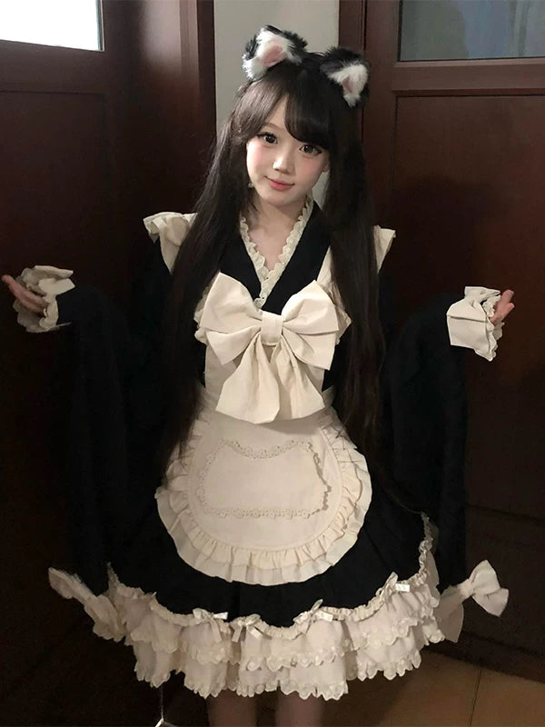 Black-and-white bow-trim OP dress with ruffled apron shown on a model.