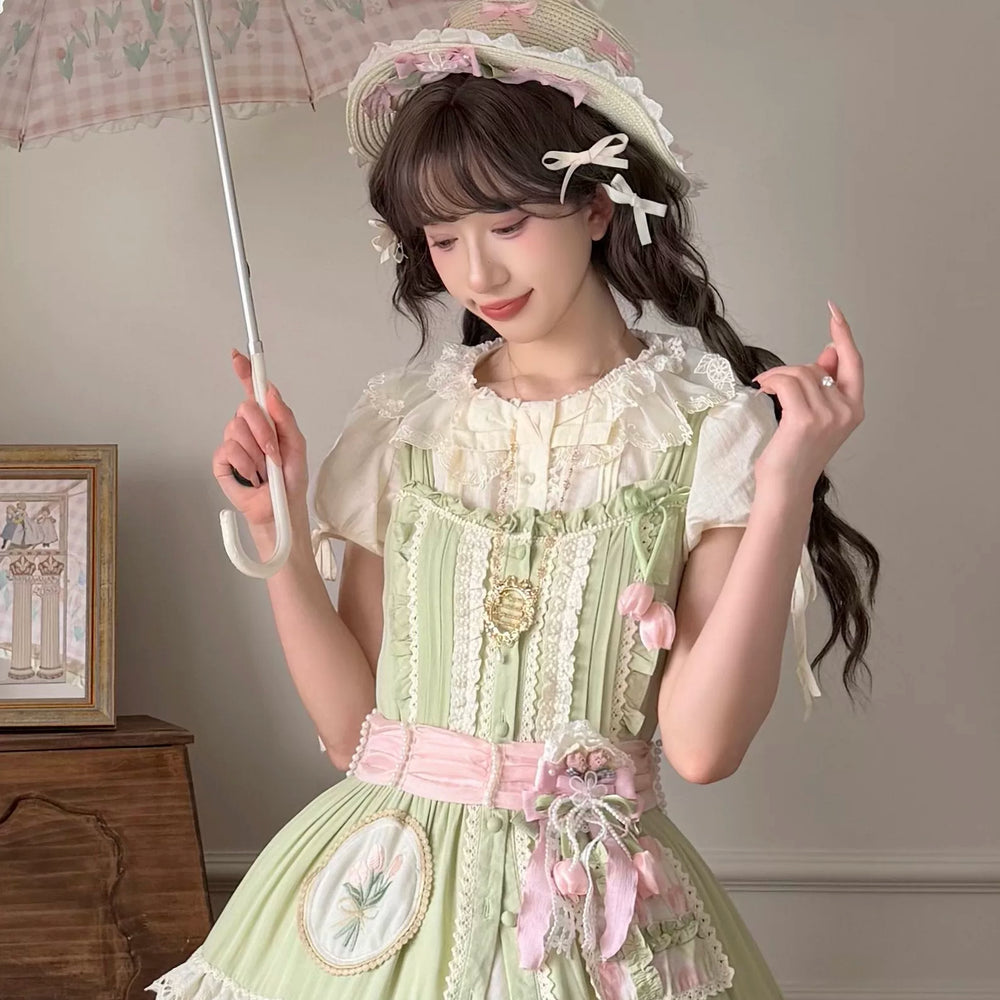 Thousand Wood tulip-themed mini top hat with layered lace and pink-and-green ribbons worn on a model.
