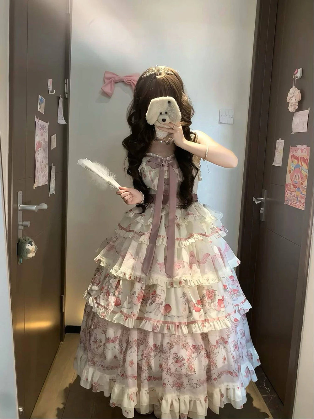 Pastel floral tiered JSK suspender dress worn in front of a mirror.