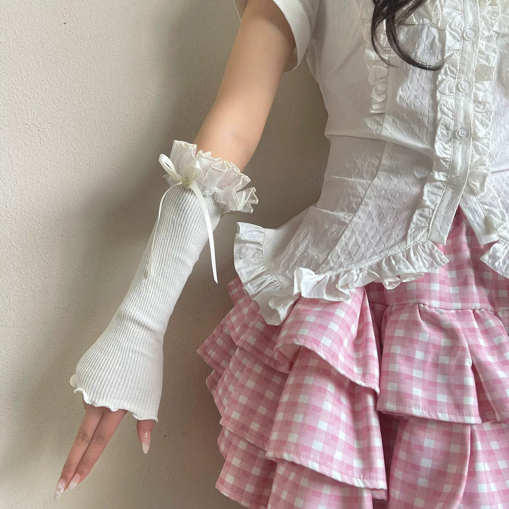 White ribbed arm sleeves with ruffled lace cuffs and ribbon bows