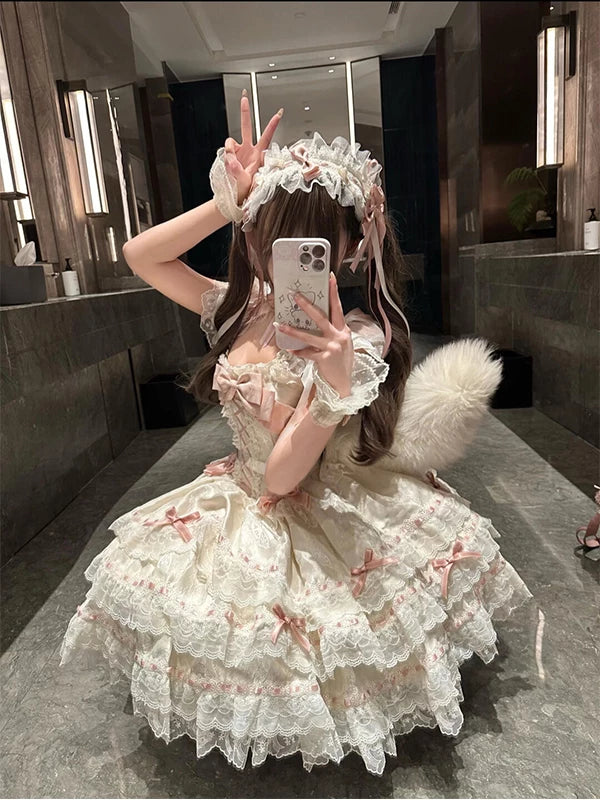 Sweet Lolita tiered OP dress with blush pink bow accents and lace trim