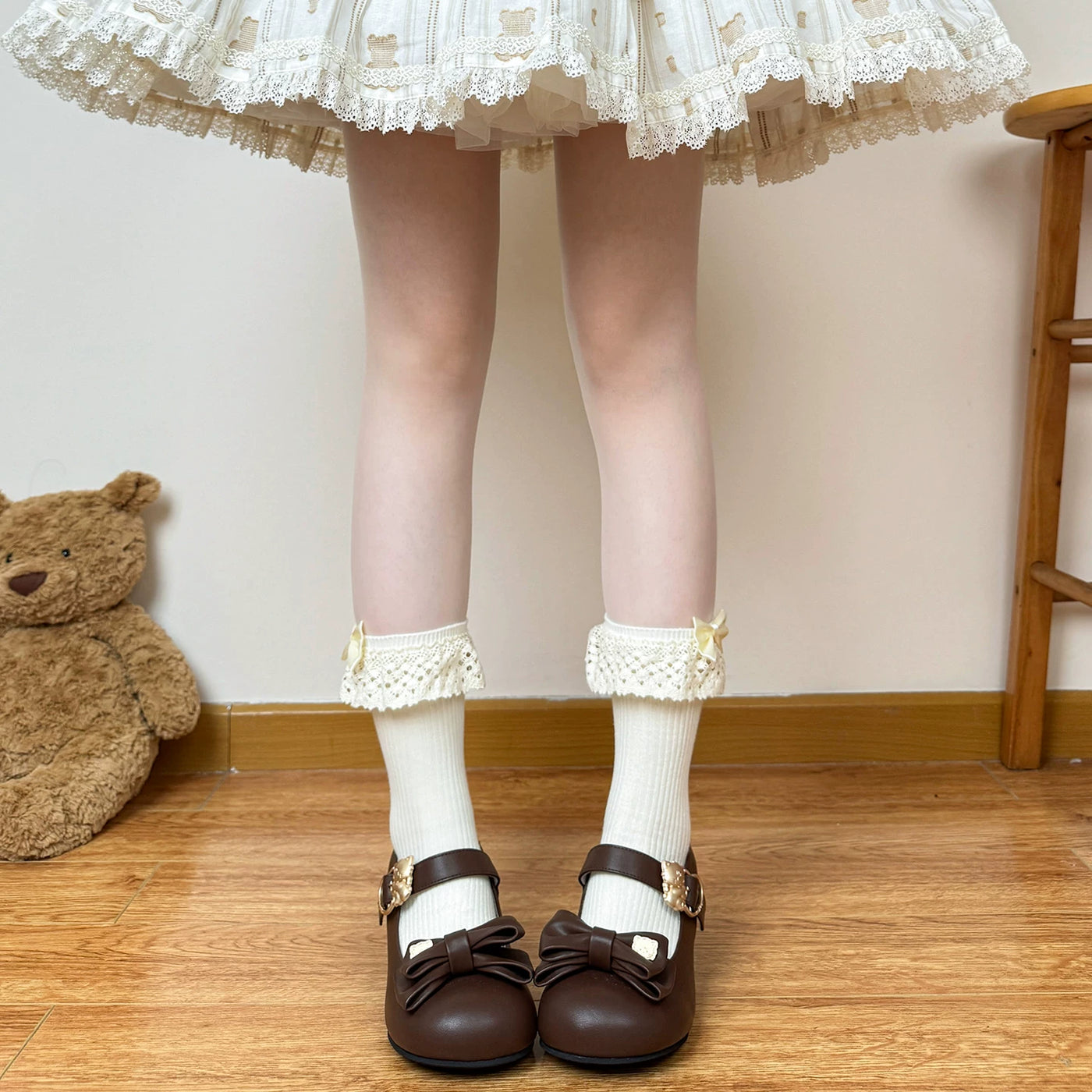 Beige and white Lolita socks with lace cuffs and bow variations shown on a model.
