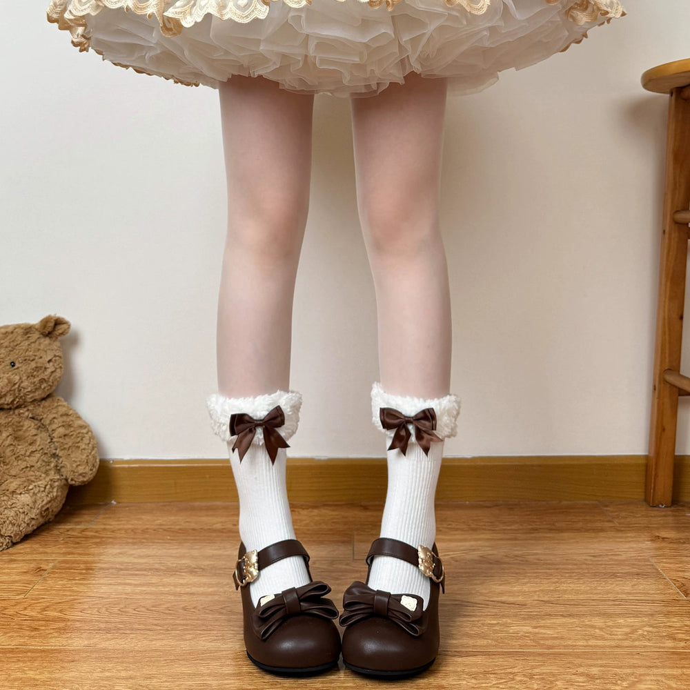 White mid-calf scrunch socks with fluffy cuffs and brown bows
