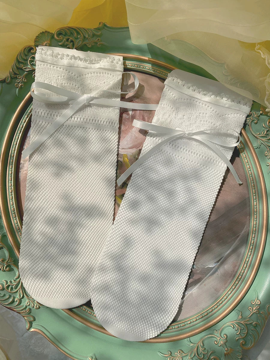 Natural white sheer lace-trim socks with ribbon bows in a romantic interior
