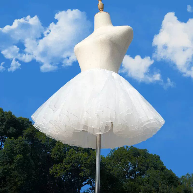 White layered-ruffle 35 cm petticoat displayed on a mannequin against blue sky