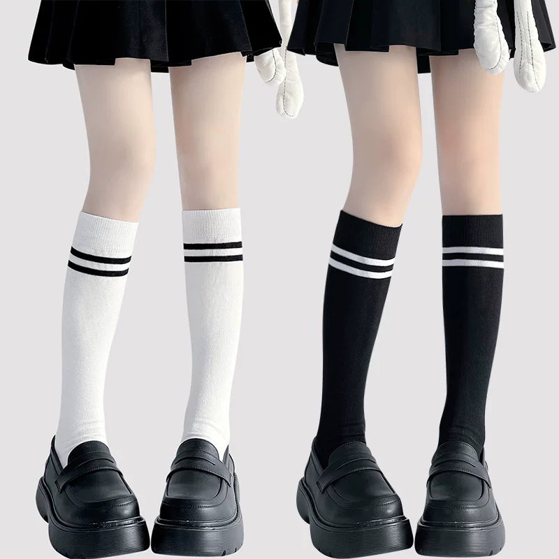 White and black knee socks with two horizontal stripes.